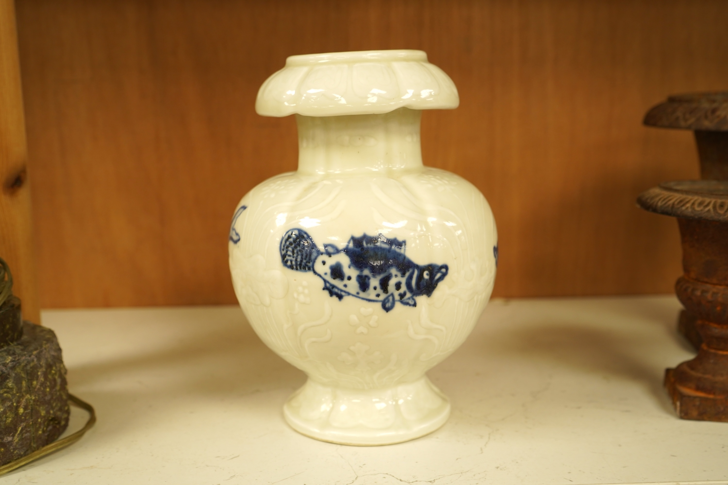 A Chinese vase decorated in low relief, hand painted with fish, 20cm high